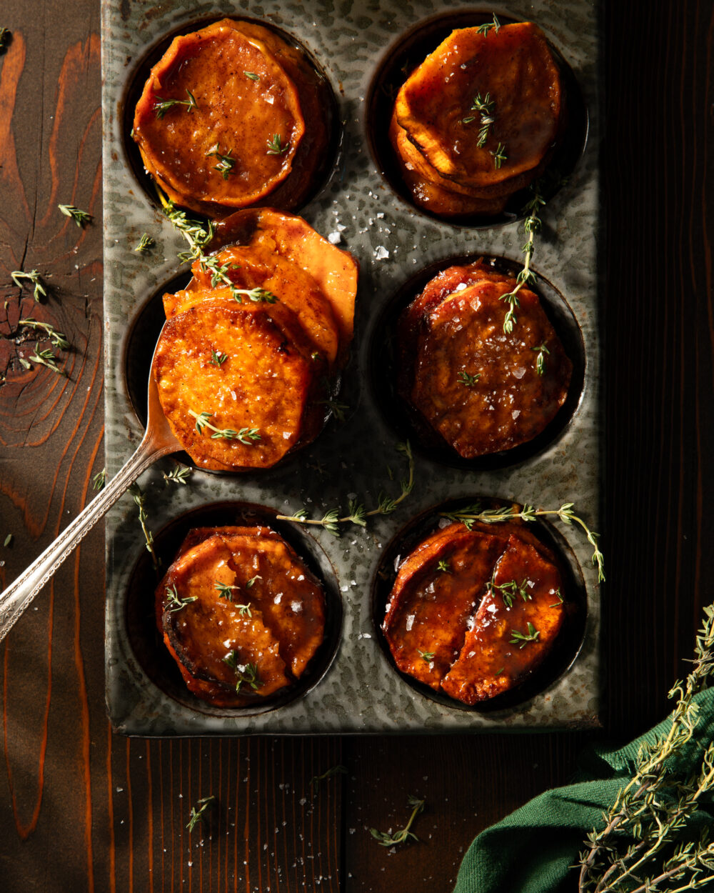 Sweet potato stacks on in a pan, glistening orange
