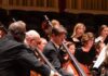 10 Must-See Classical Concerts of Fall 2025 People in the classical symphony in Pittsburgh play upright basses on stage.