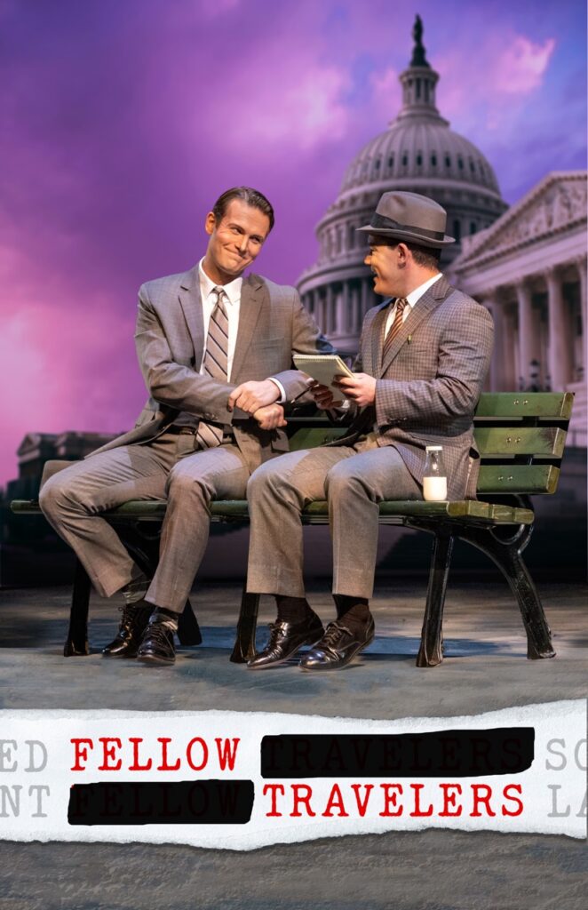 Two men in suits sit on a bench, looking at each other.