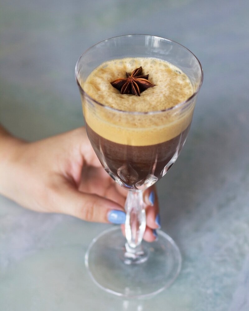 An iced caffè coretto with a garnish of anise.