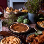 A brown sugar pie sits on a table with other southern dishes.