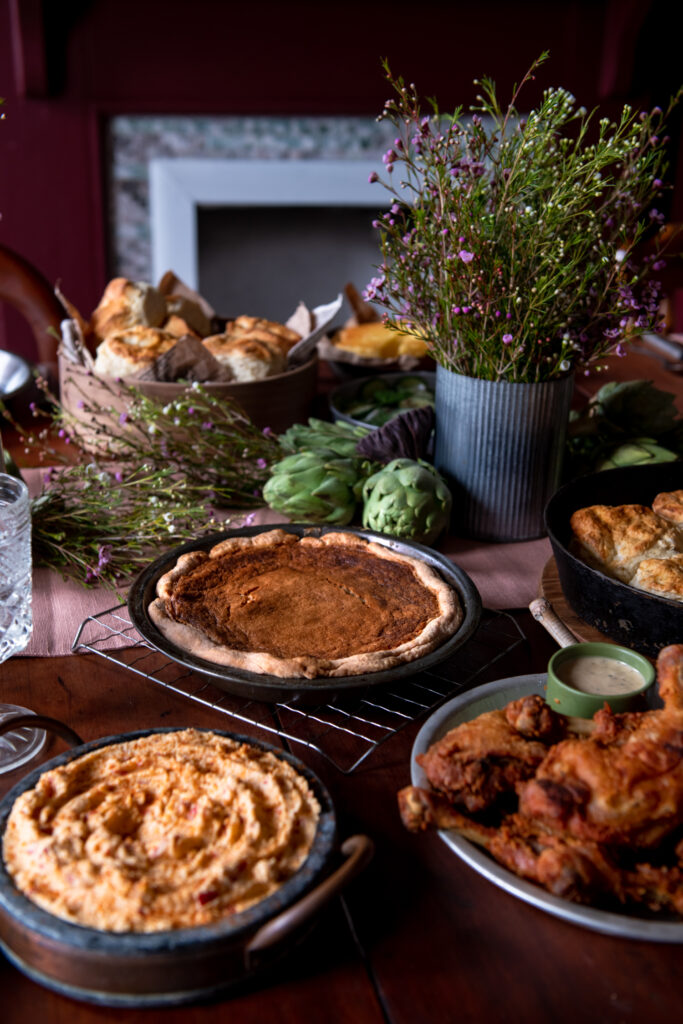 A brown sugar pie sits on a table with other southern dishes.