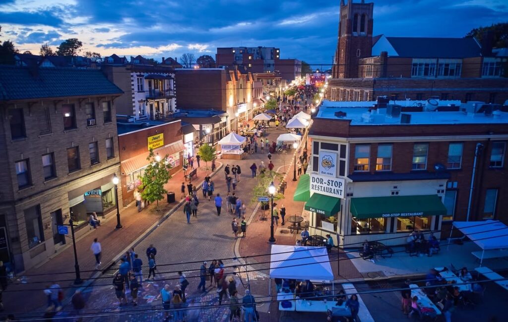 Nighttime view of a Pittsburgh fall festival with food vendors and crowds