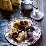 A plate of dutch boffert with a small bowl of jam beside them.