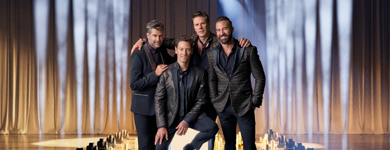 Il Divo quartet posing in black suits