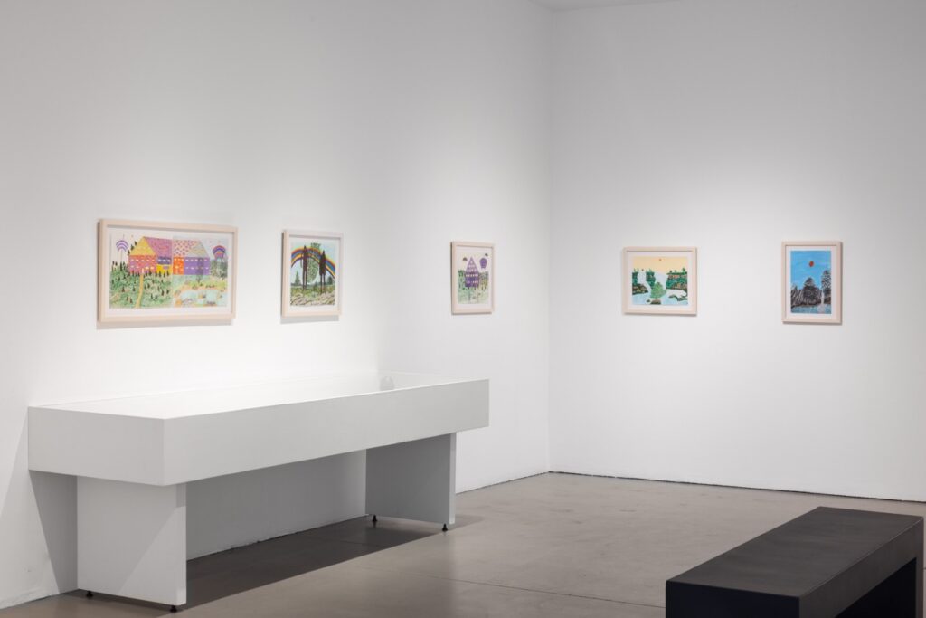 A gallery space with images on the walls.