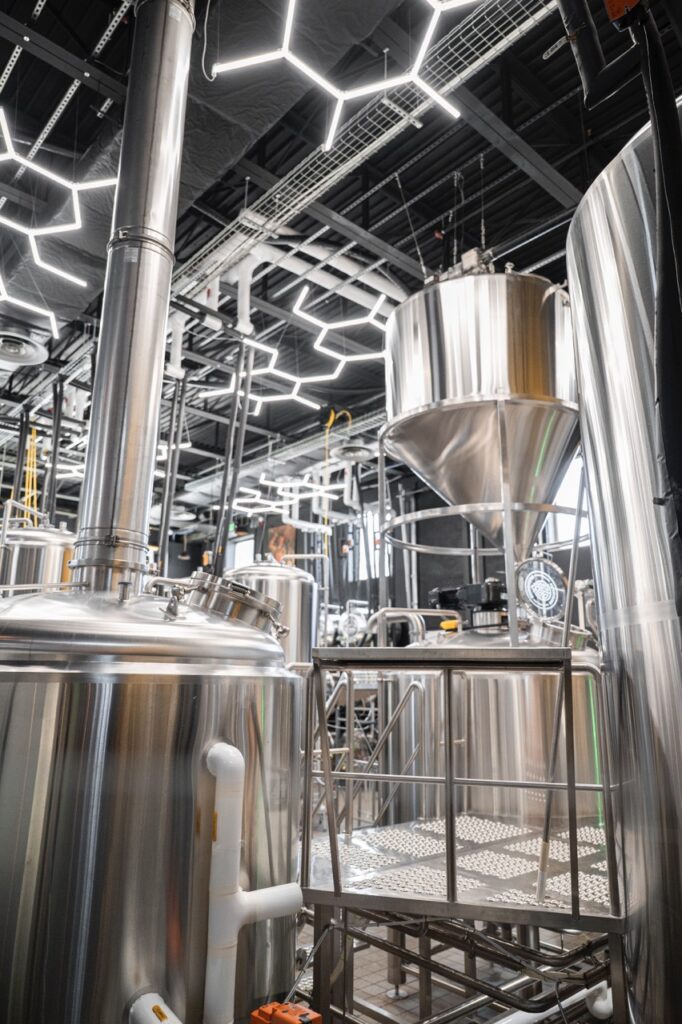 A bunch of metal silver brewing vats.