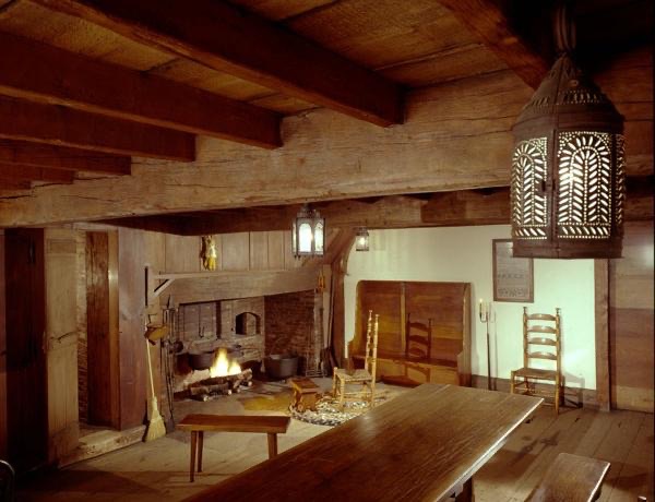 The inside of a wood room from early America.