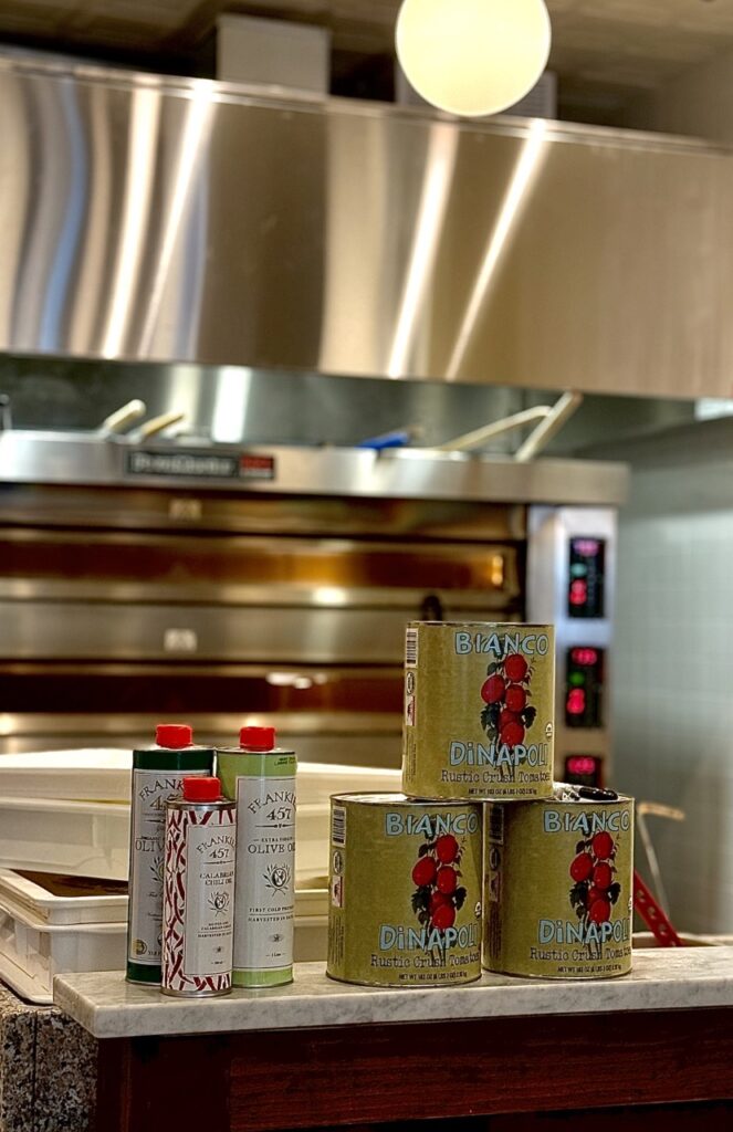 A stack of tomato cans on top of a kitchen counter.