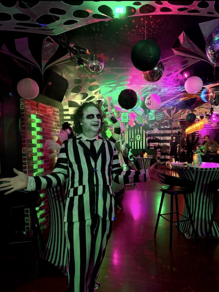 Beetlejuice character in a decorated bar, Pittsburgh Halloween bars theme