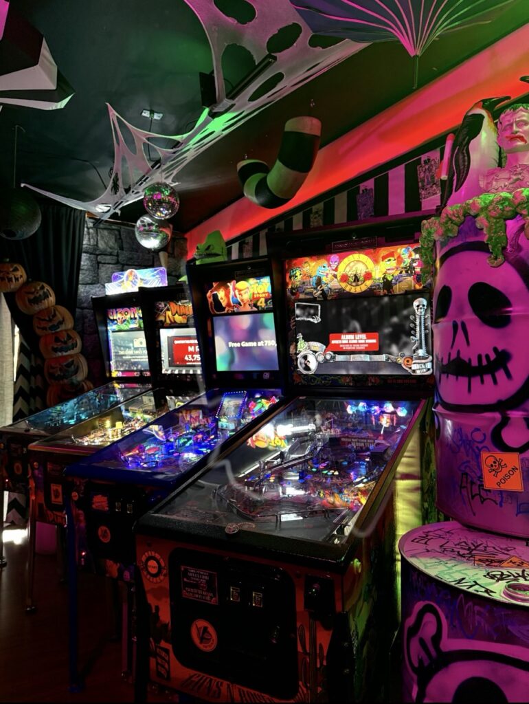 Halloween-themed arcade with pinball machines and spooky decor in Pittsburgh