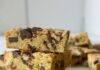Blondie Recipes for Fall Baking and Sharing A stack of Samoas Blondies sits on a marble table top with more in the background and a few Samoas in the front of the frame.