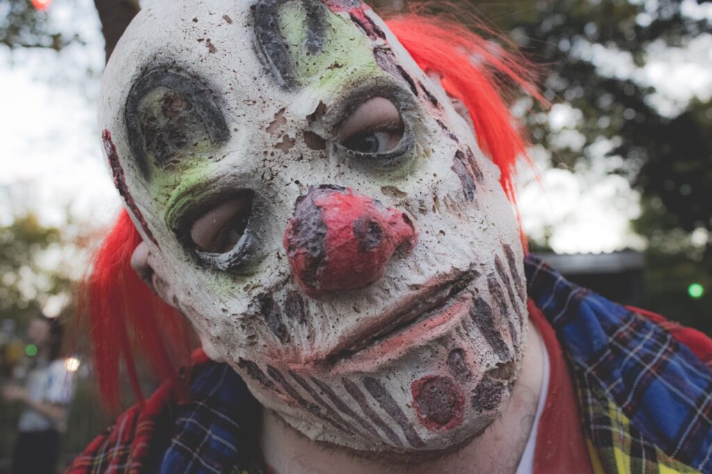 A decaying clown mask up close.