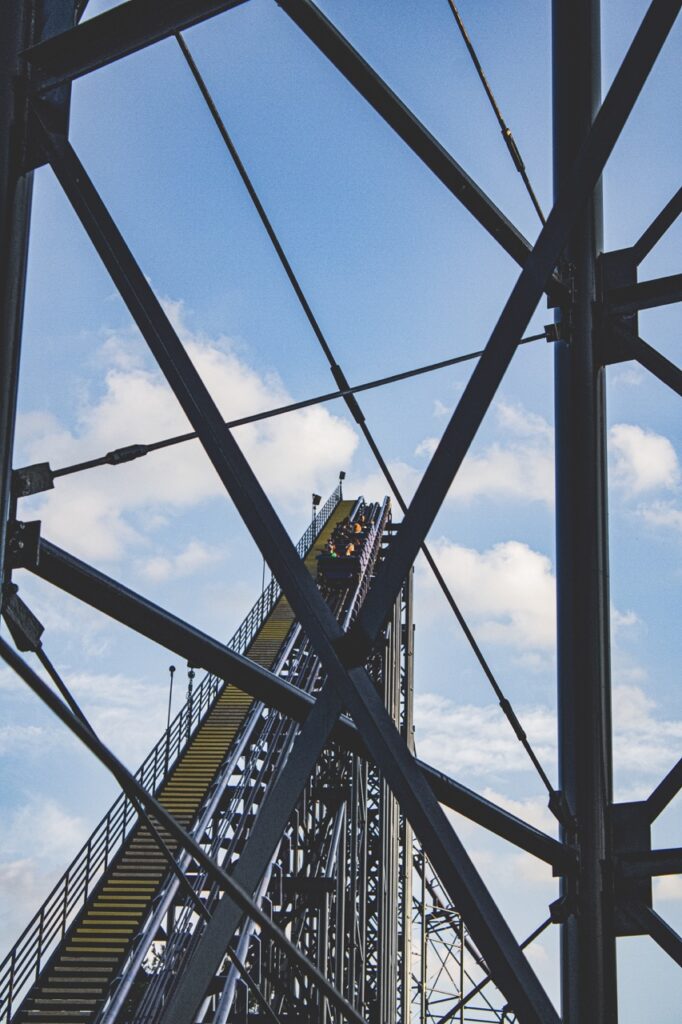 A rollercoaster goes up the first hill.