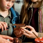 Ganache-Stuffed Chocolate Chip Cookies Kids spreading ganache on a cookie