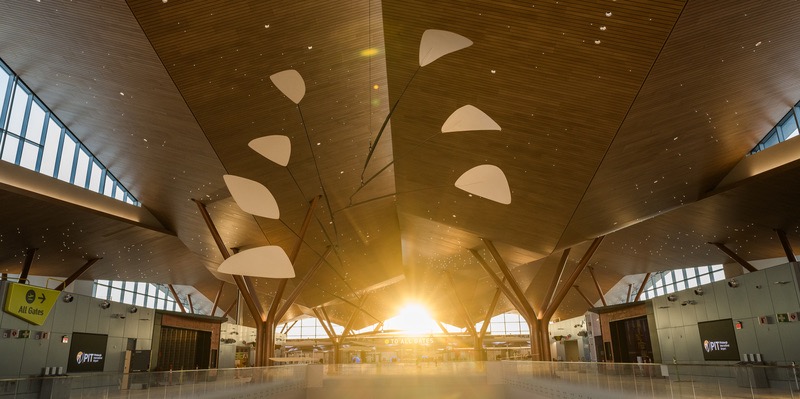 The inside of the Pittsburgh Airport terminal with the sun peaking through.