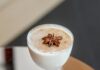 Shake Up a Coquito, a Puerto Rican Christmas Cocktail A chilled Coquito cocktail in a coupe glass, garnished with a star anise and cinnamon, for a Puerto Rican holiday drink.