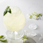 A limoncello spritzer cocktail on a white background