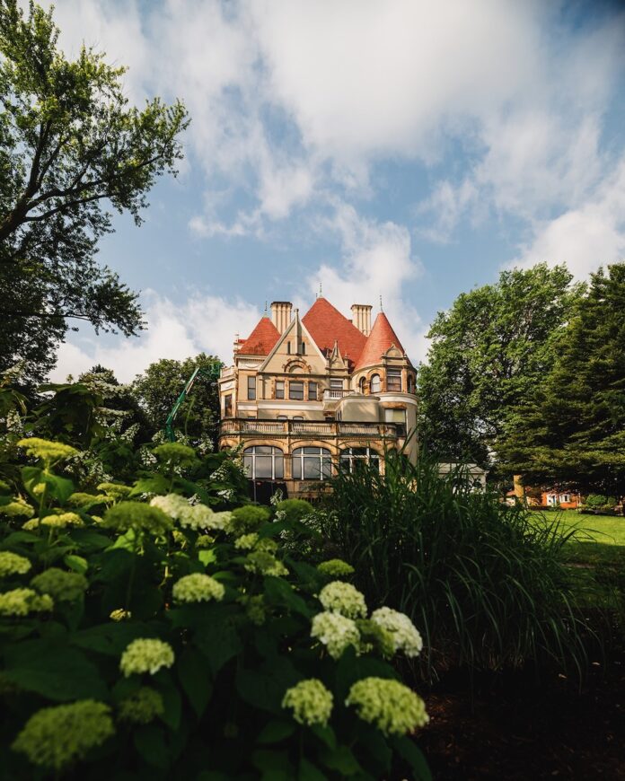 The Frick Opens Up Never-Before Seen Floors of Clayton The outside of The Frick Clayton house in the distance, surrounded by trees.