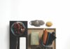 Travel Around the World with Samples Chosen By Marvista Design + Build Interior design mood board for a luxurious kitchen with black floral wallpaper, leather, brass hardware, and a bowl of kidney beans.