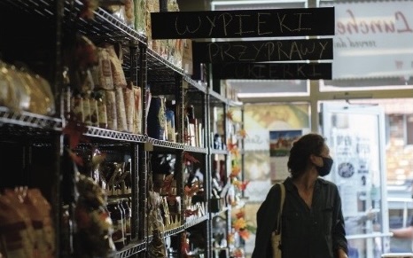 lady with mask on inside local grocer