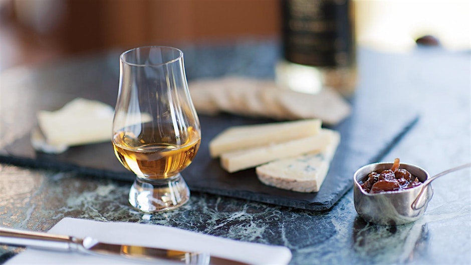 Whiskey and Cheese Pairing on dark stone table