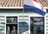 Smells Like Chocolate in Zaandijk lady looking out blue chocolate shop doors