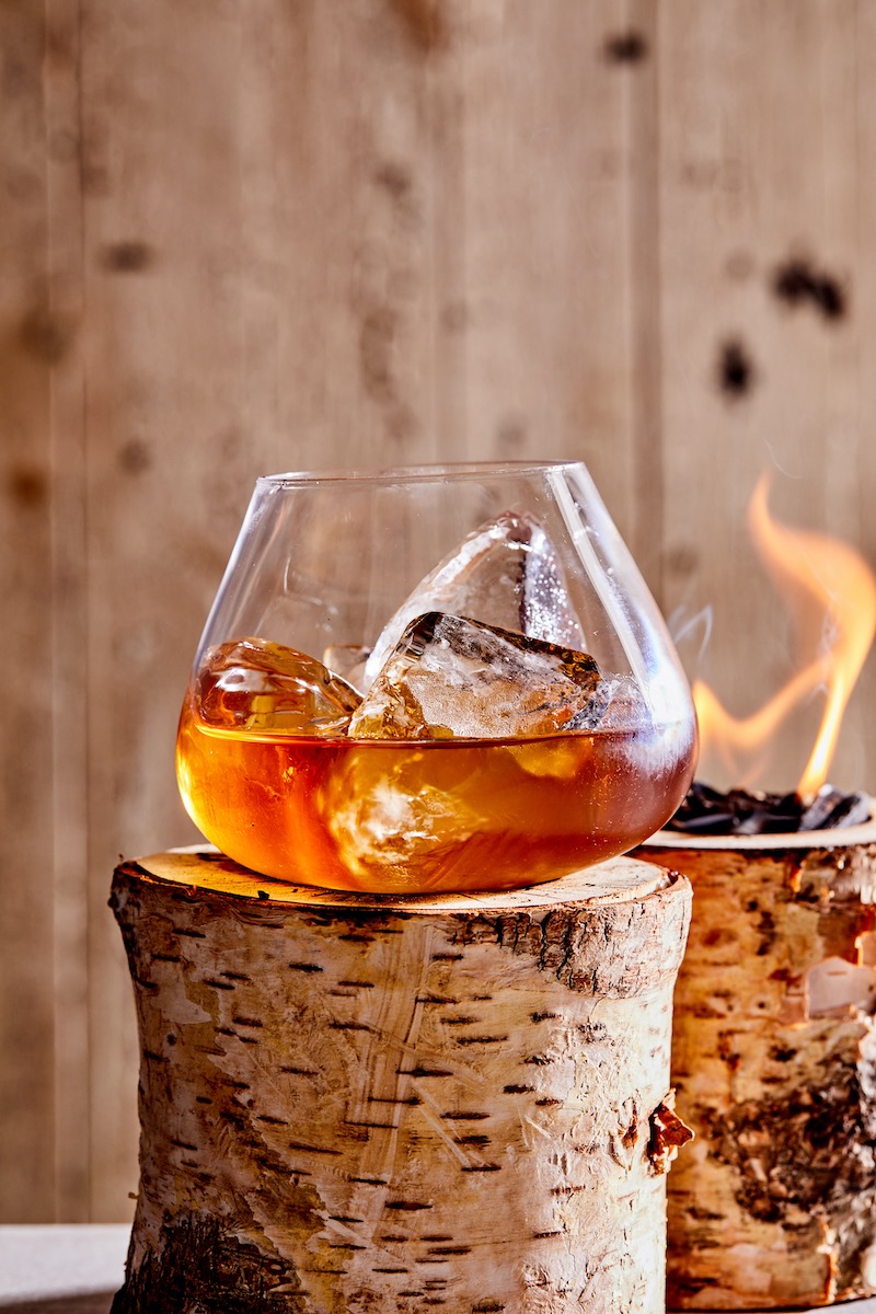 The Appalachian Trail, a cold weather cocktail, sits on a smoked birch log