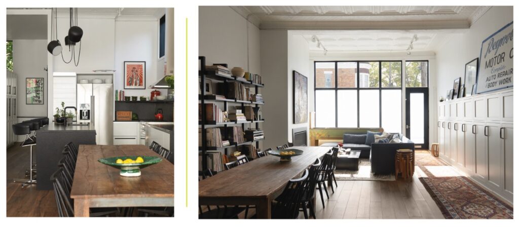 A renovated Pittsburgh storefront interior featuring an open kitchen, a long wooden dining table with black chairs, and a bright living area with tall frosted windows and original pressed tin ceilings.
