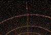 12 Places to See Holiday Lights Near Pittsburgh A person walks under a tunnel of lights at Pittsburgh Botanic Garden's Dazzling Nights.