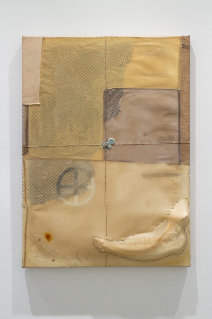 A patchwork painting on a gallery wall.