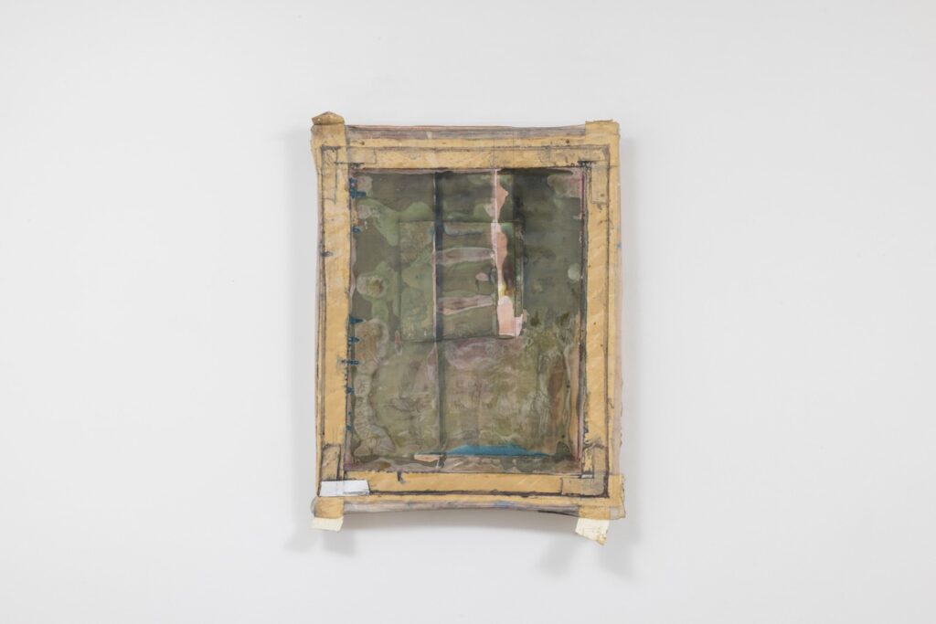 A green muddy painting in a wood frame on a gallery wall.