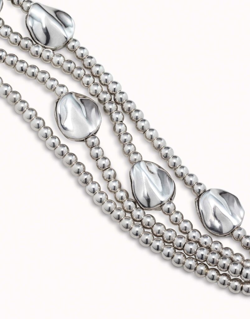 Four silver bracelets with chunky gemstones.