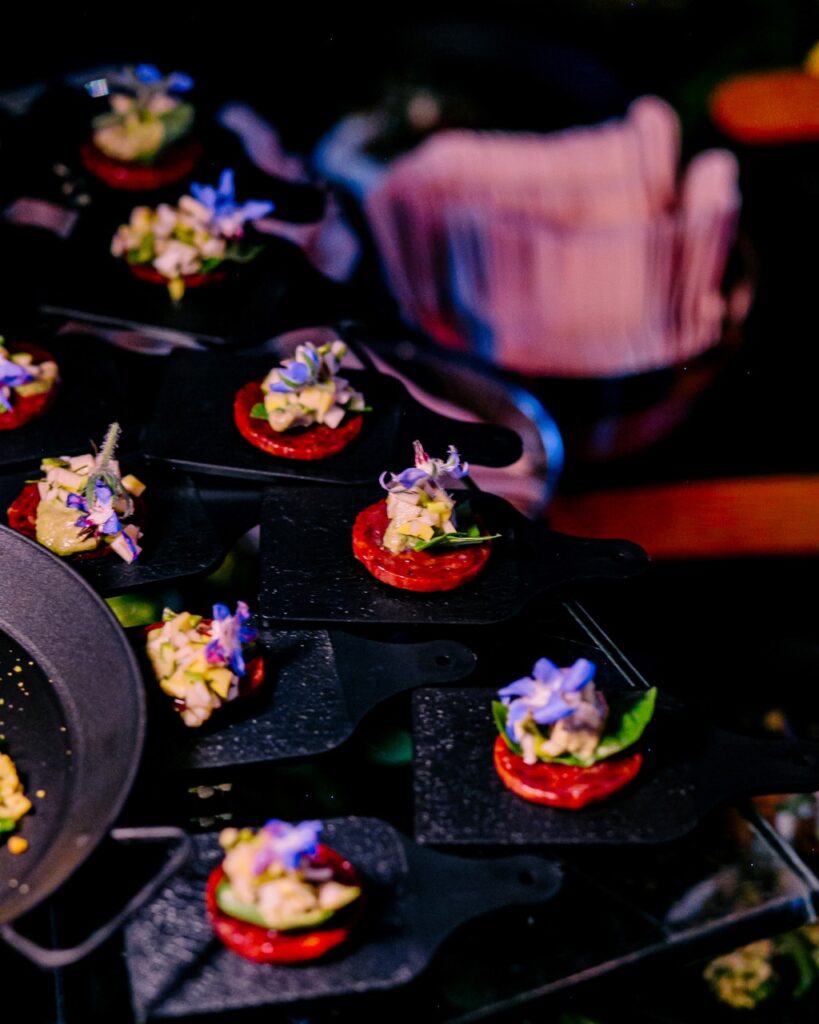 Small appetizers on little black cutting boards.