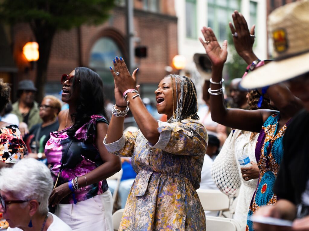 A crowd claps for musicians.