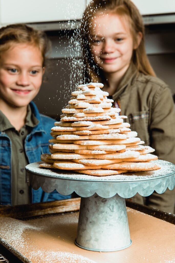 Sugar Butter Star Cookie stacked up with kids looking at them