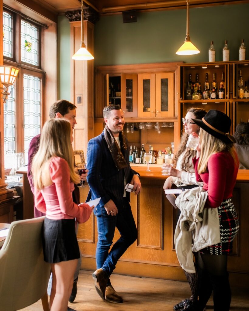 TABLE Publisher Justin Matase chatting at the bar at Mansions on Fifth