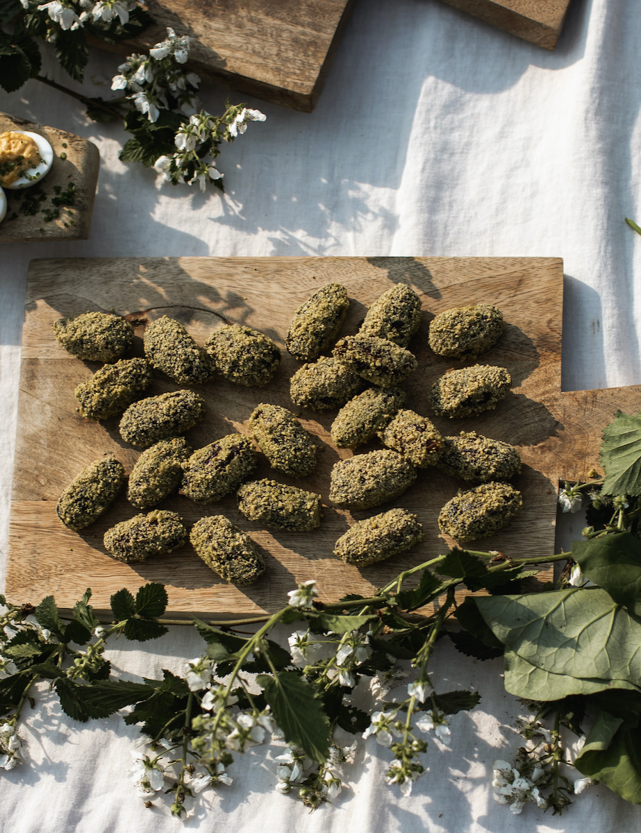 A set of goat cheese stuffed dates on a cutting board