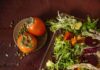 Winter Chicories Salad with Persimmons and Avocado Colorful salad with tomatoes on side