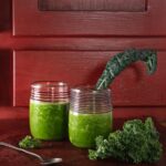 Two cups with green liquid inside