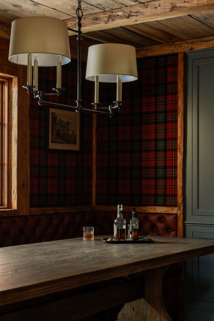 A counter area in a home with lights and a plaid wall.
