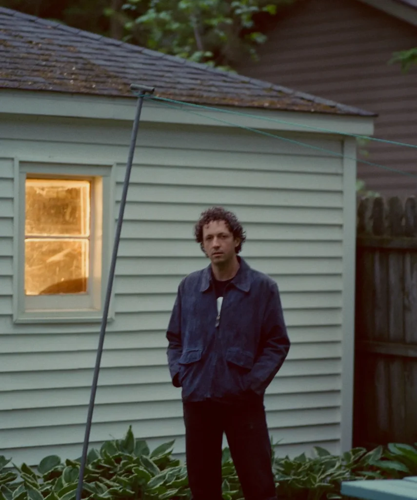 Liam Kazar w/ Brad Goodall standing in a backyard