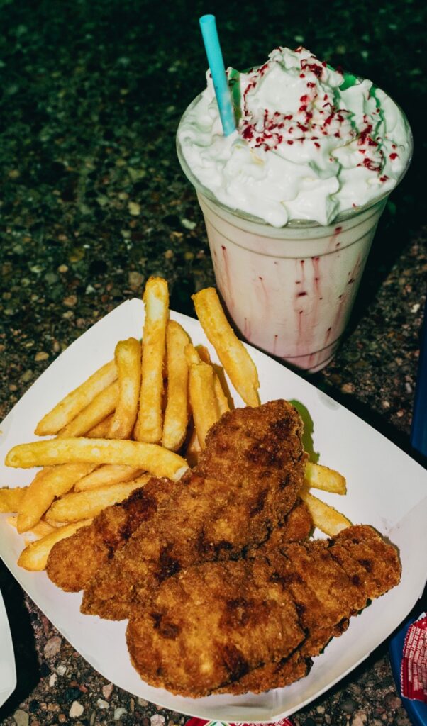 Chicken tenders and fries in a basket with a peppermint shake.