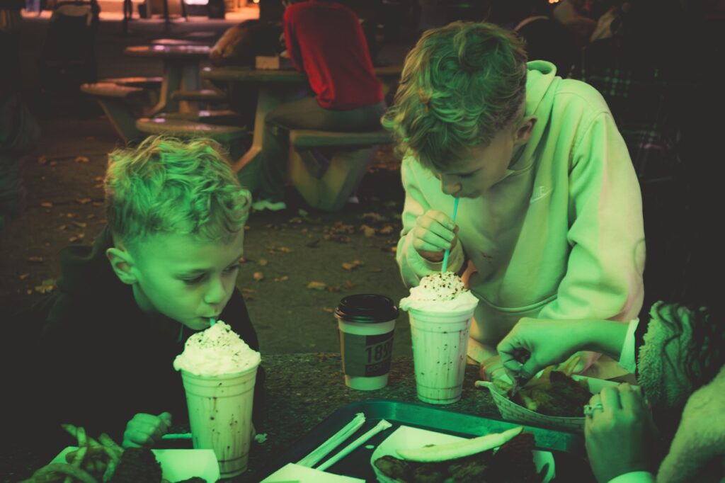 Two boys drink peppermint milkshakes.
