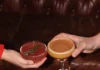 Pittsburgh Events: Your Guide to January 5-11 A variety of cocktails sit on a wood table as two hands each grab one.