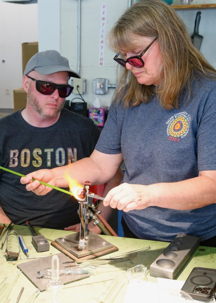 8 Classes in Pittsburgh to Help Start Your New Year's Resolution An instructor shows a student how to blow glass in a class.