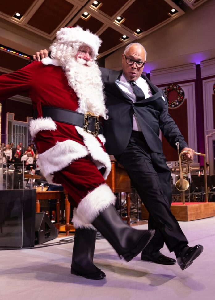The Pittsburgh orchestra conductor dances with Santa at a holiday event.