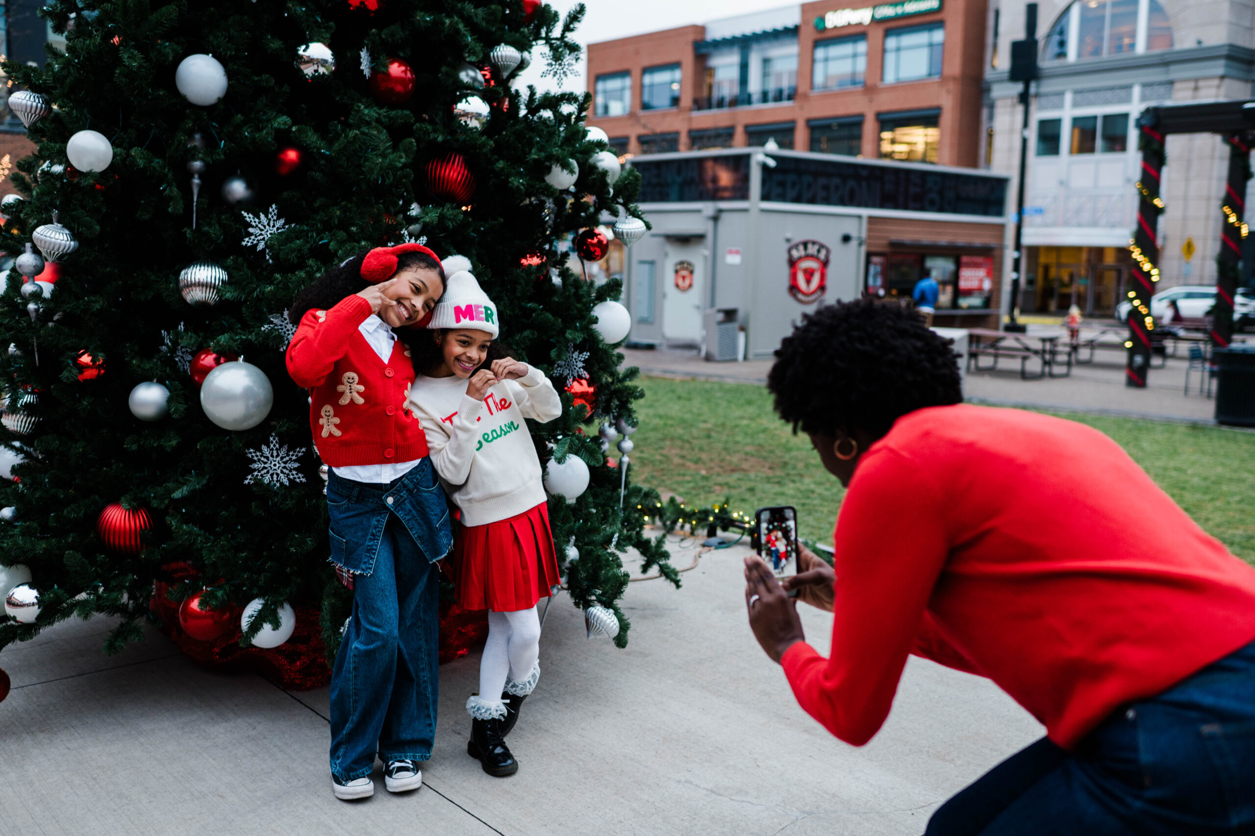 Holiday Spectacular & Merry & Bright Market, girls getting pictures with a christmas tree. 