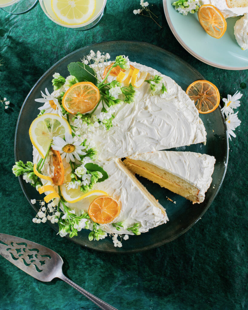 A Stanley Tucci inspired delizia al limone layer cake on a green background