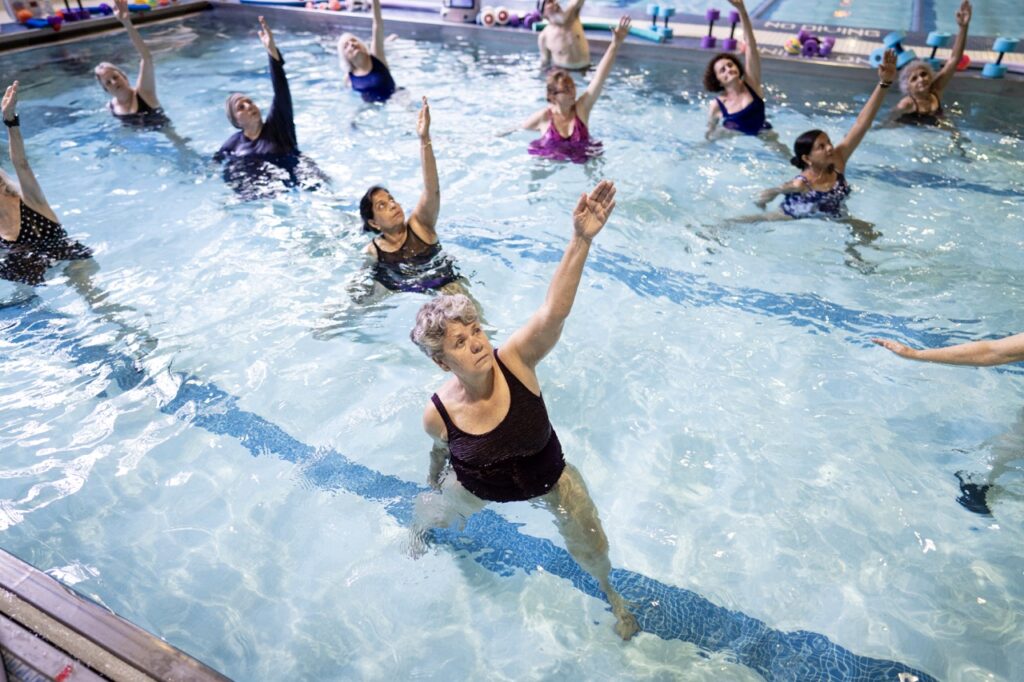 Women exercise in a swimming pool.